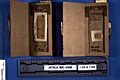AFDIL Photo depicting two open slide mailers each with glass microscope slide marked: 'Q96 L2082 PMS' and scale marked: 'AFDIL #: 99C-O438 112A & 115A'