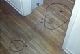 Bloody footprints of Jeffrey MacDonald in hallway, exiting the bedroom of Kristen MacDonald.   CID Exhibit D216, a right footprint located between the two circled areas, was made in Type A or AB blood, the blood types of Colette and Kimberley MacDonald, respectively.<br><br>CID Exhibit D215 (circled at right) was made by Jeffrey MacDonald's left foot, in Type A blood.  A third print, CID Exhibit D217 (circled at left) was also made by Jeffrey MacDonald's left foot in human blood, type unknown.